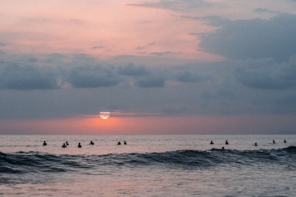 Jacó beach with surfers in the water