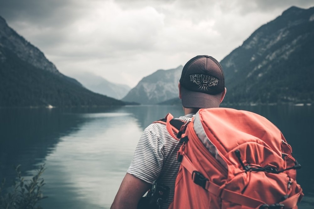 guy with orange backpack for travel