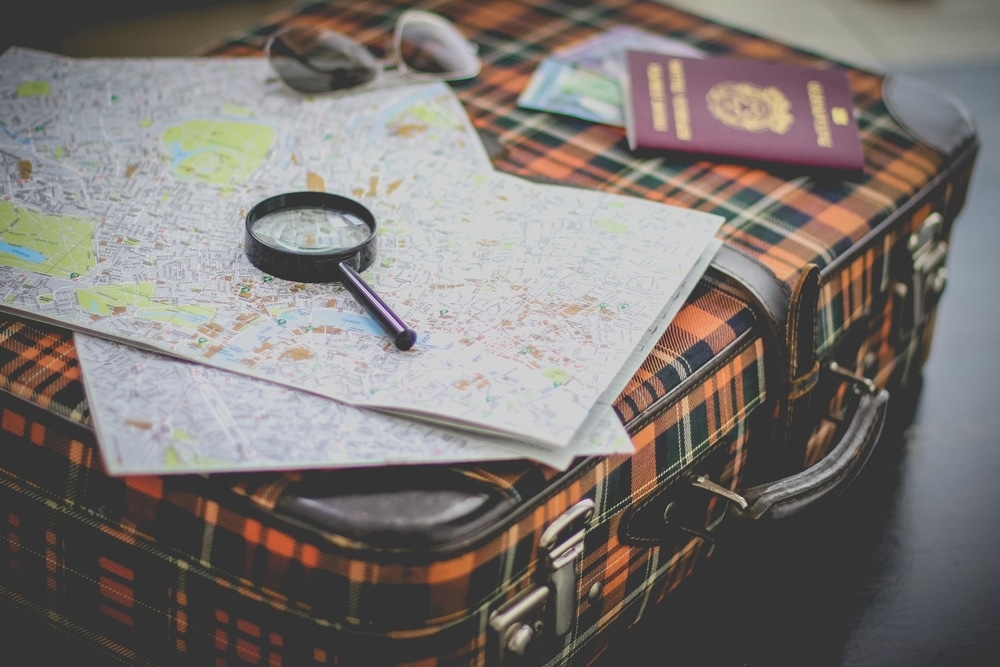 travel suitcase map and magnifying glass