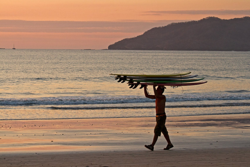 Playa Tamarindo sunset surfers