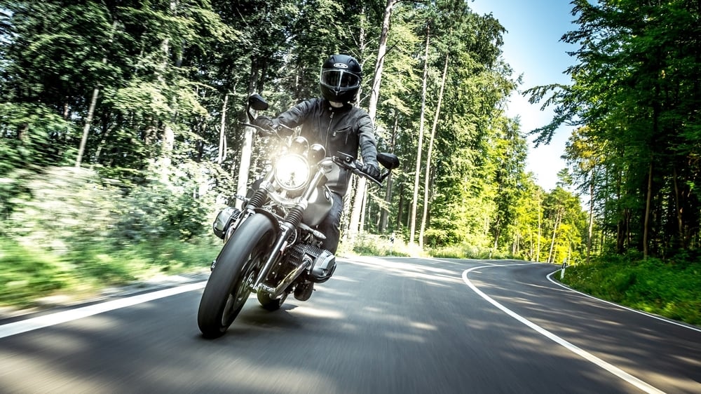 Man riding motorcycle in forest