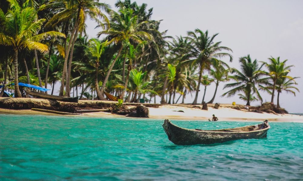 Canoes floating on blue seas in San Blas Islands, Panama