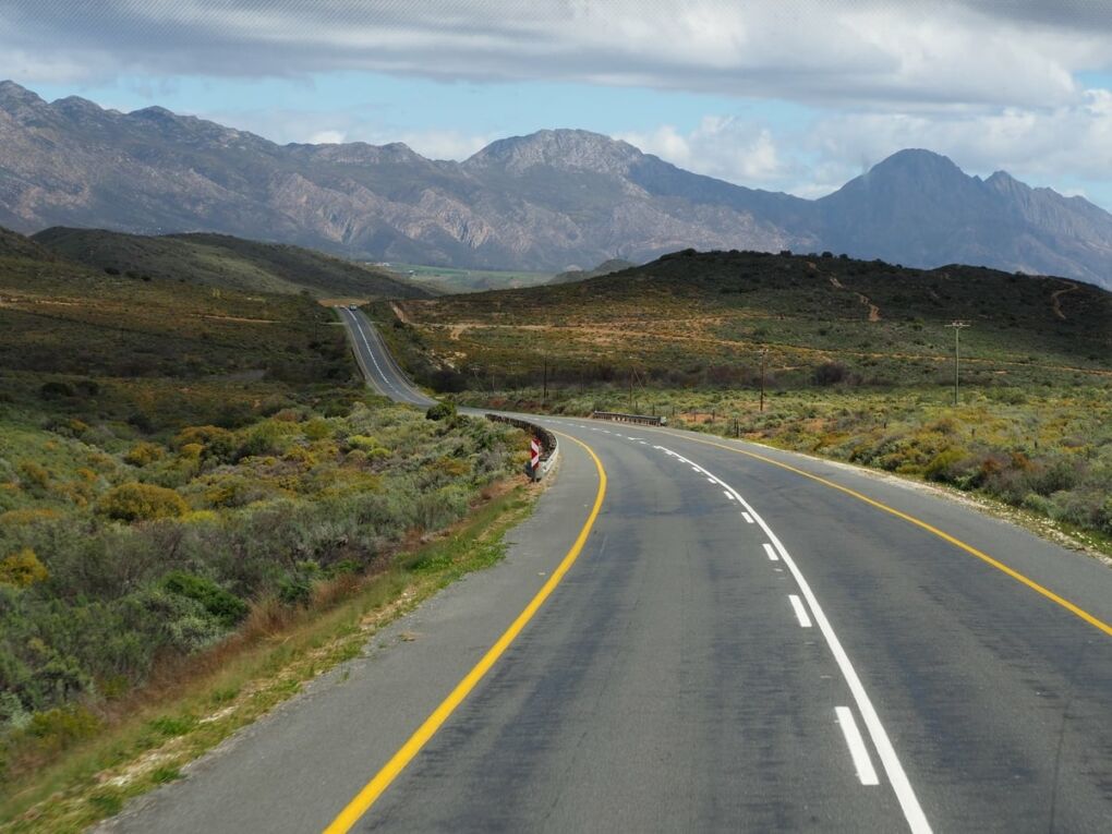 Garden Route road disappearing into mountainous landscape