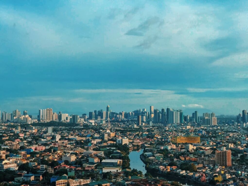 Manila City skyline under blue sky during daytime