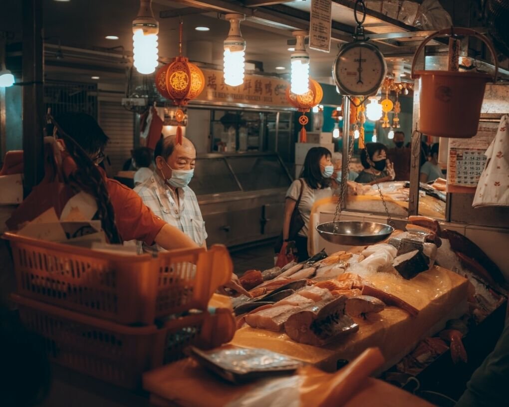 Man buying fish at one of Singapore's early morning markets in Holland Village