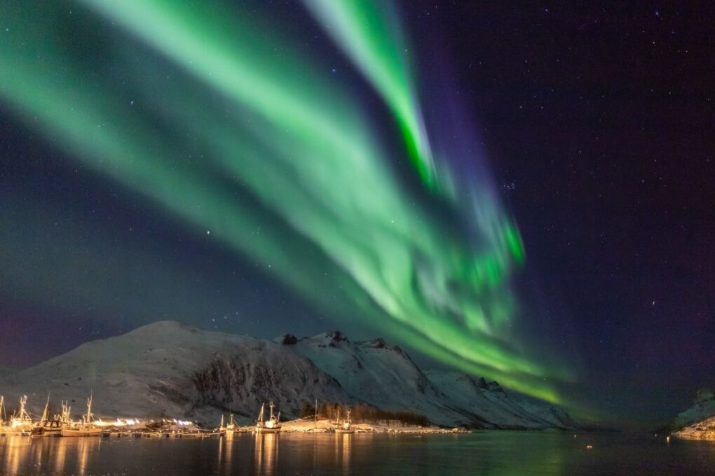 Northern lights over Tromso City and mountains in Norway