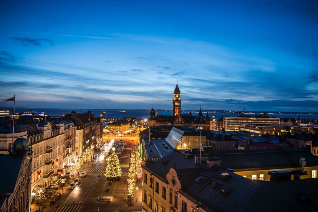 Aerial shot of city with high rise buildings and sea in the background during the evening in Helsingborg City, Sweden
