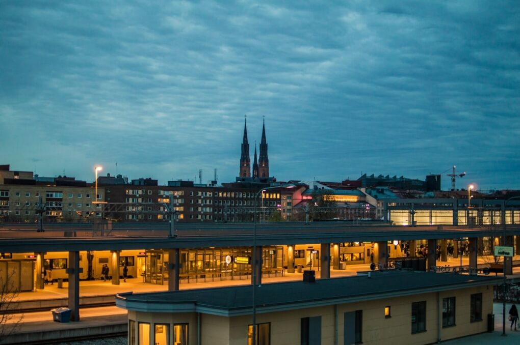 Train station with buildings in the background and blue evening sky in Uppsala city, Sweden