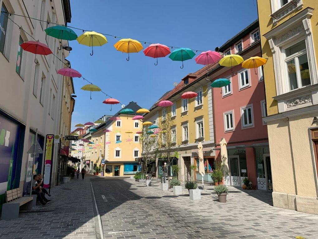 Street filled with umbrellas in Villach, Austria