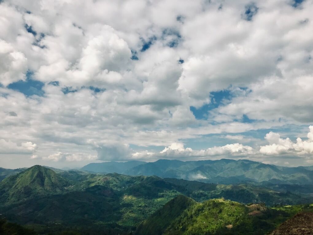 White clouds over green mountains in Davao City