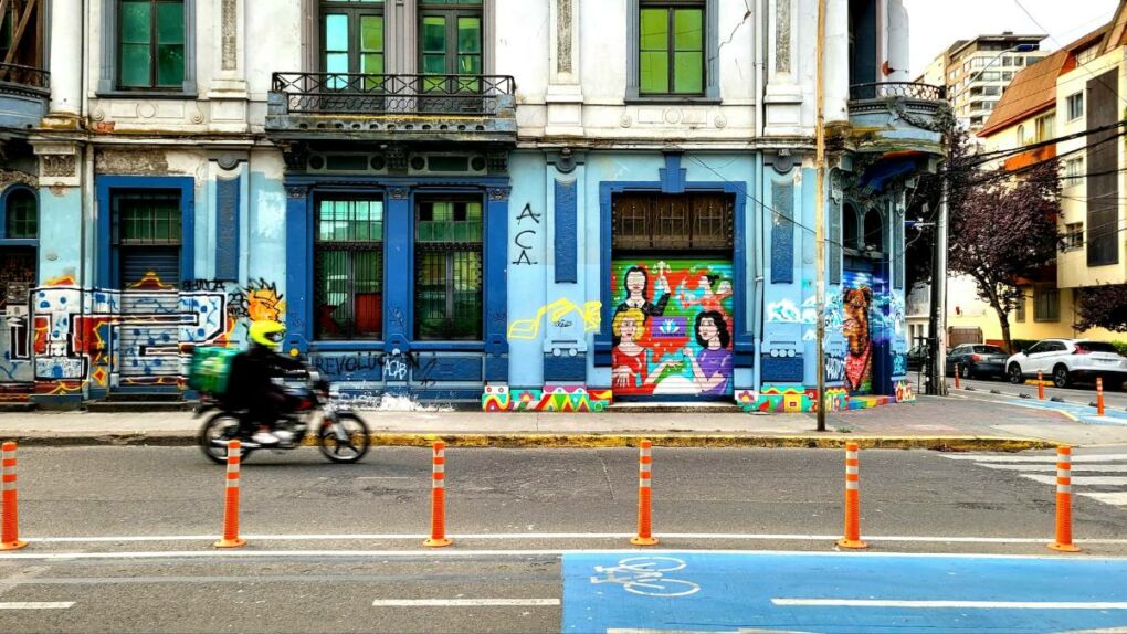 Colorful street art on building in Concepción with motorbike in street