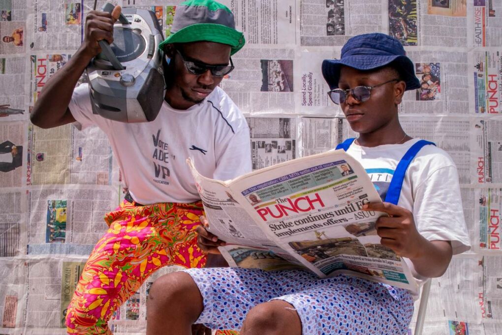 Young people reading a newspaper