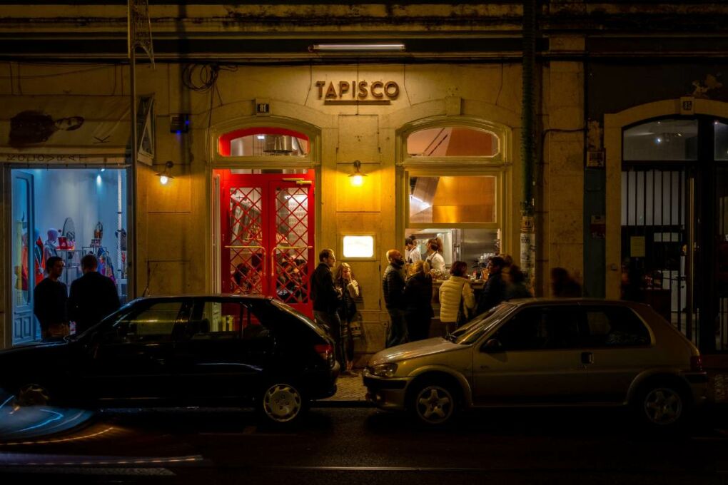 A photo of a classic Lisbon tapas bar at night 