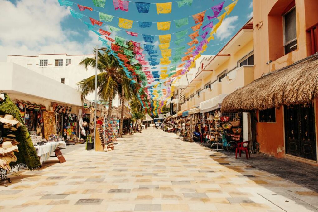 A street of local shops and boutiques on a sunny day in Mexico.