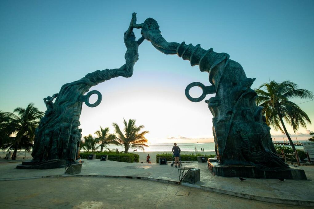 A modern sculpture of two women appearing to be sea creatures. 