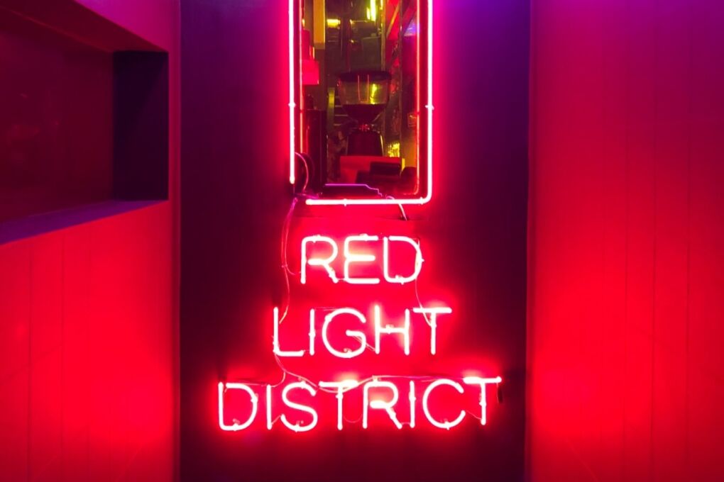 Red neon sign displaying the words "Red Light District"