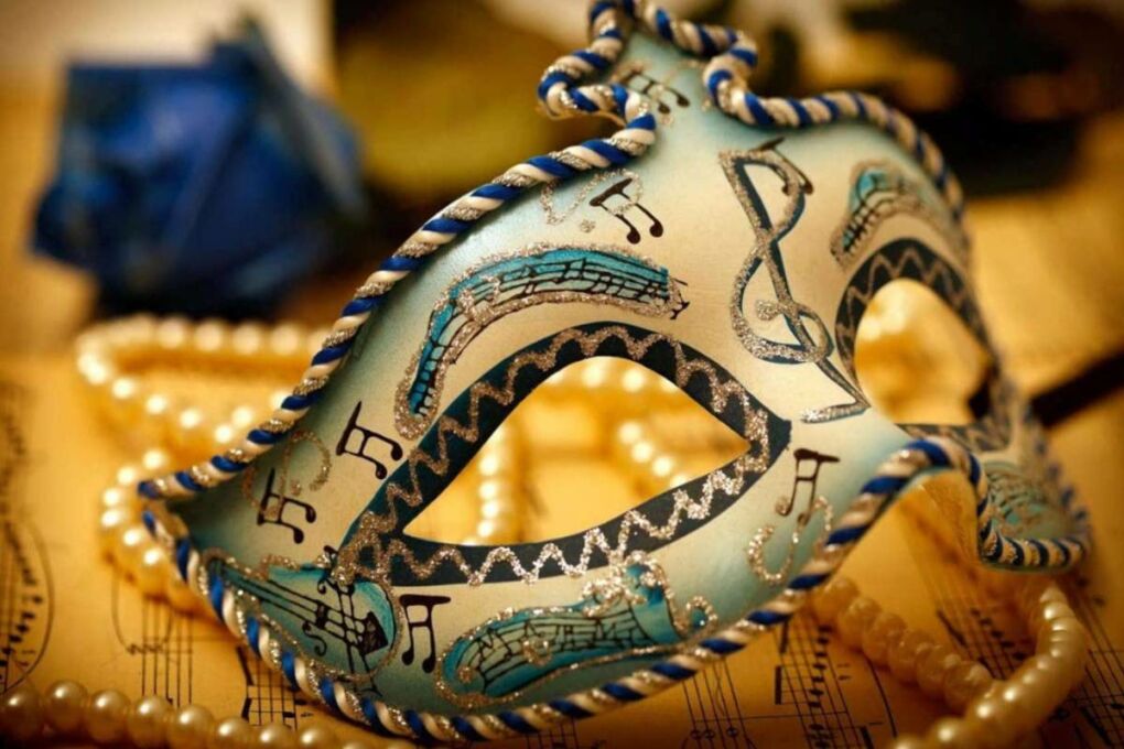 A intricately detailed Mardi Gras mask with music notes on it.