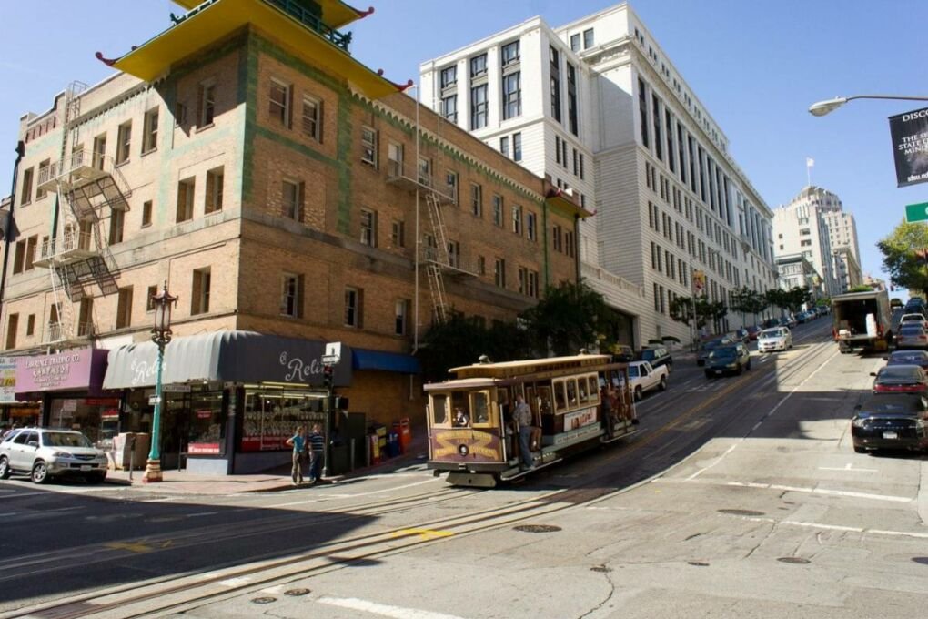 A street cart going through an intersection.