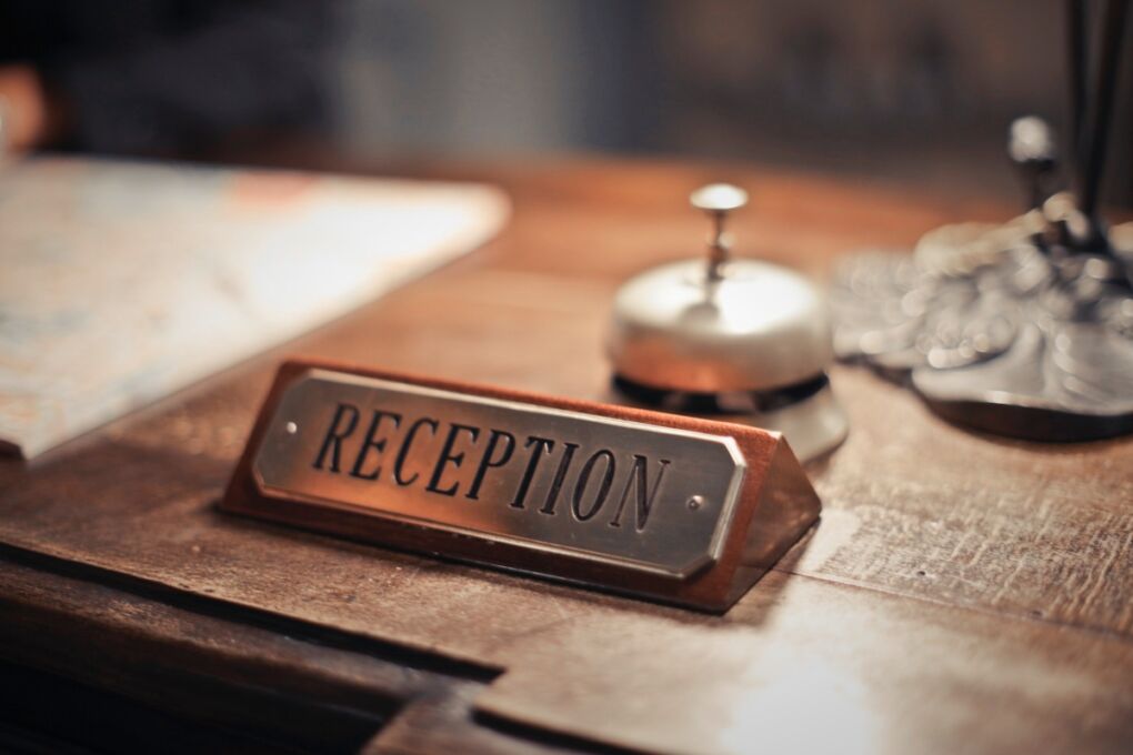 A reception sign on a hotel front desk