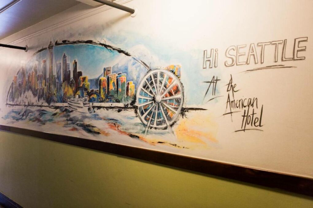 A mural of the Seattle City skyline inside of the  Seattle hostel at the American hotel.