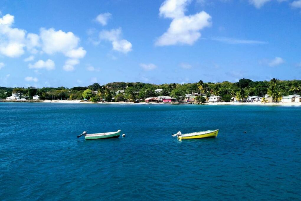 Two boats floating in a calm bay in Barbados 