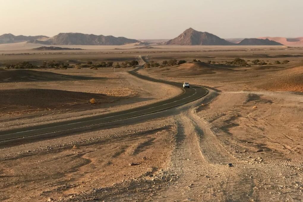 A car driving on a quiet road in Namibia