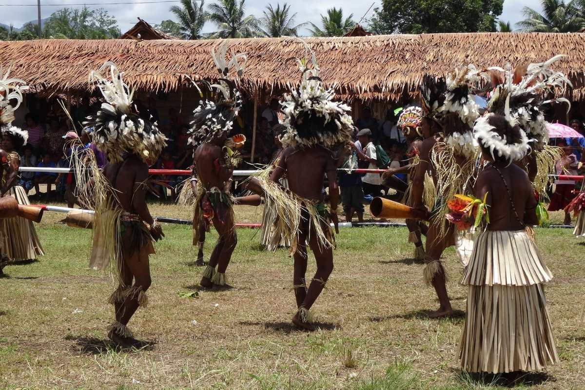 New Guinean tribal people dancing in their traditional clothes