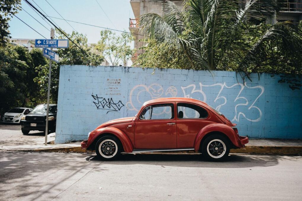 Car parked in front of a vandalized wall in Playa del Carmen