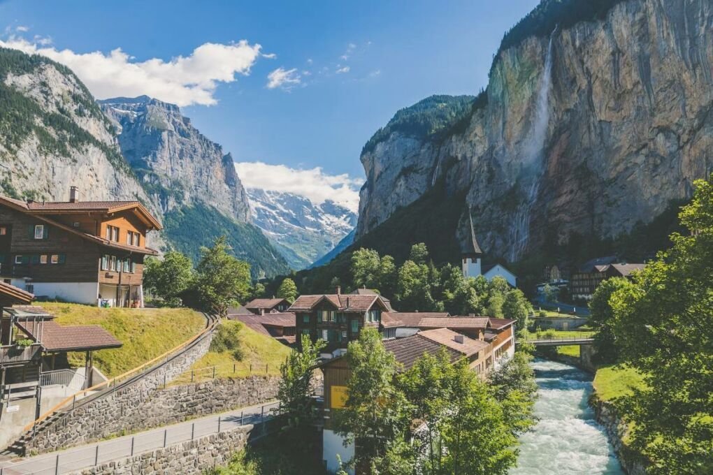 Image-of-valley-houses-in-switzerland|image-of-black-painted-house-in-Arnisee|image-of-city-lights-in-Bern|White-and-brown-concrete-building-in-daytime|Image-of-snow-covered-houses-and-mountain|Image-of-red-swiss-train-on-mountains|Image-of-small-houses-in-a-meadow-in-passwang|Image-of-a-ski-lift-above-a-mountain|image-of-waterfall-over-green-land-in-lauterbrunnen|