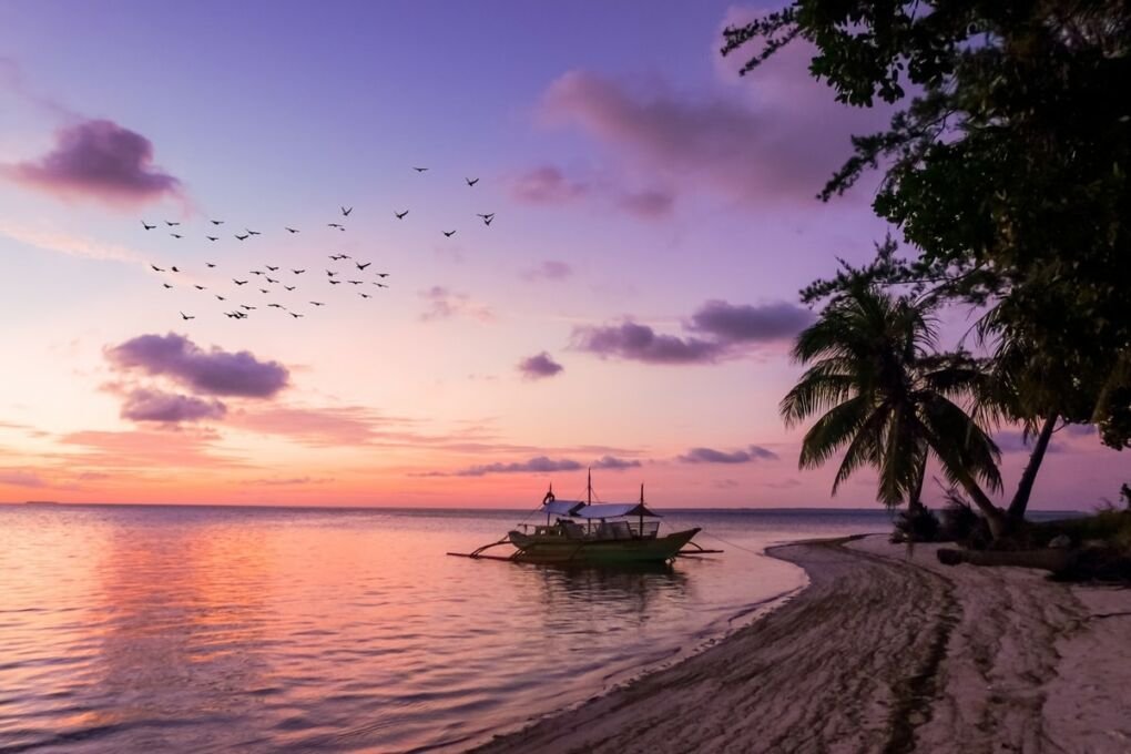 Sunset over boat on seashore in Balabac, Philippines||||||||||