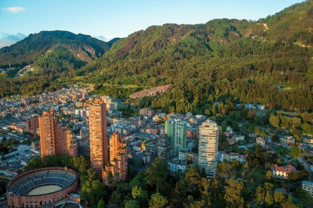 View of Bogota an the Andes Mountains|Aerial view of Bogota|Bogota city lights at night|Bogota skyline|Colorful street in Bogota|Moserrate mountains in Bogota|Coloful street art in Bogota|Tequendama Falls Bogota|Tourist exploring the La Candelaria neighbourhood|Urban area in Bogota