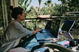Woman working remotely with her laptop on a table outside
